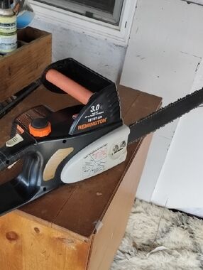 Remington Black Chainsaw with Orange Accents and Cream Panel